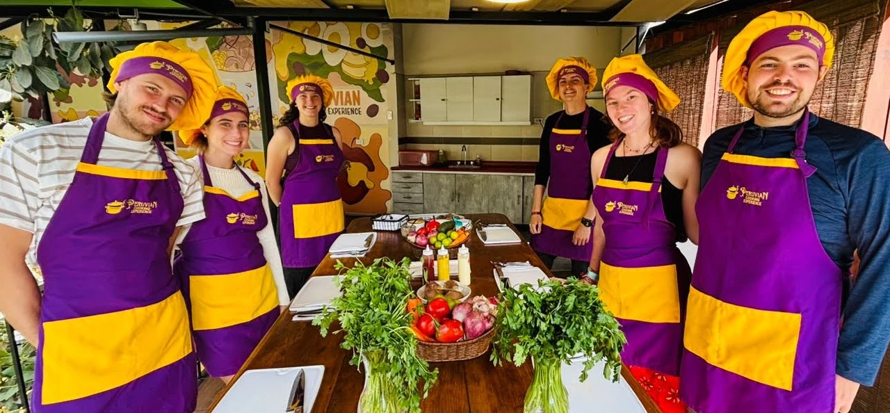 Travelers getting comfortable at their individual stations before the hands-on Peruvian culinary journey in Arequipa